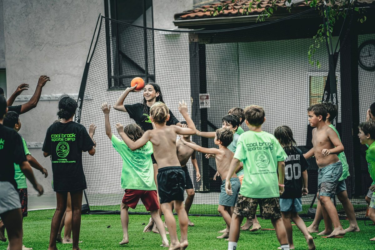 Kids swarming in a dodgeball game at camp