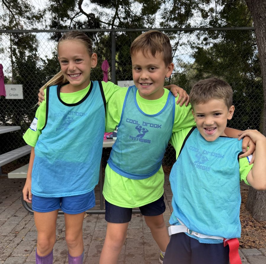 Three smiling campers with arms around each other