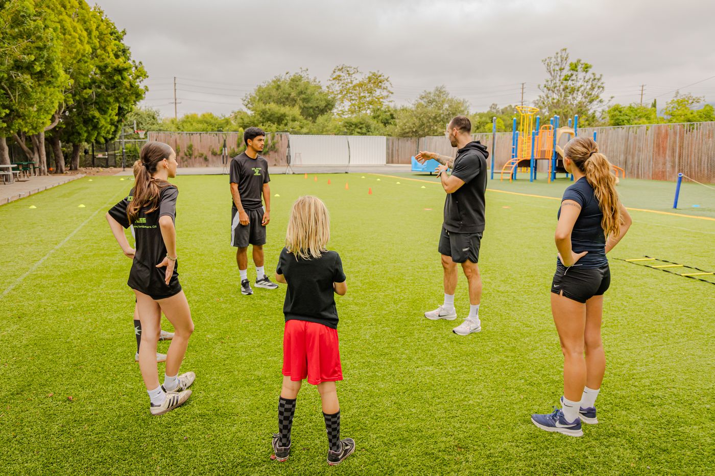 Coach Tovi leading a group instruction circle