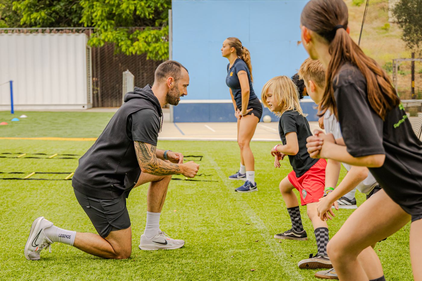 Coach Tovi coaching a speed drill on the field