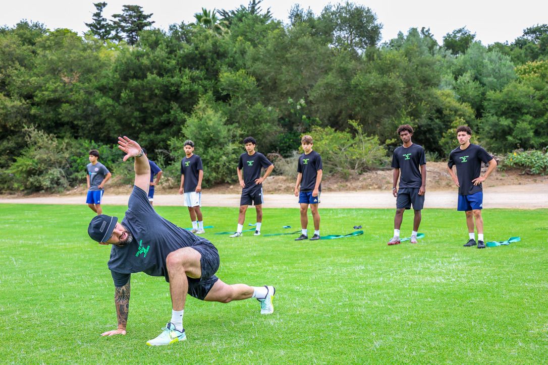 Coach demonstrating a drill for the squad
