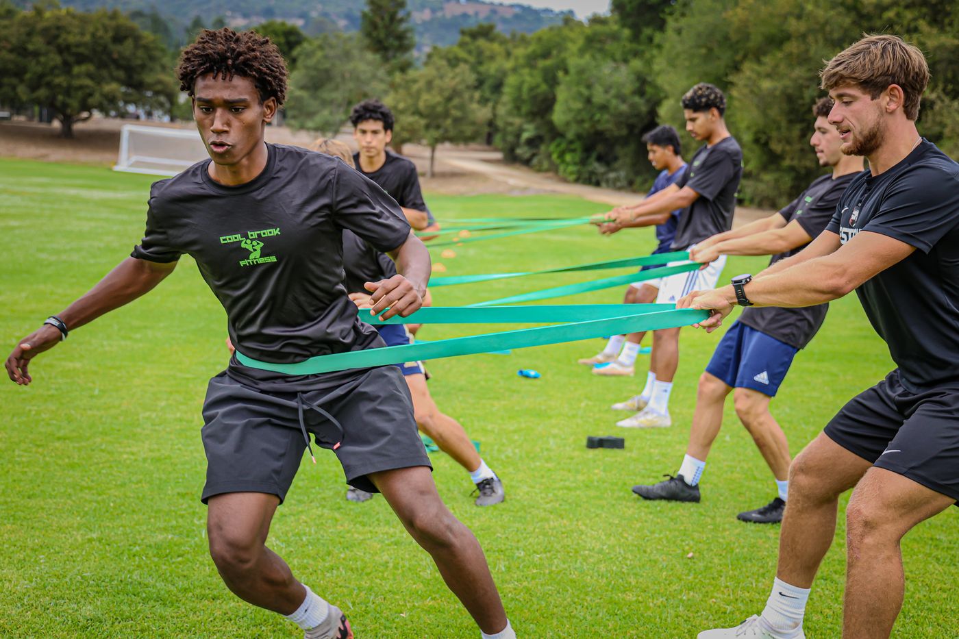 Athletes doing resistance-band sprints