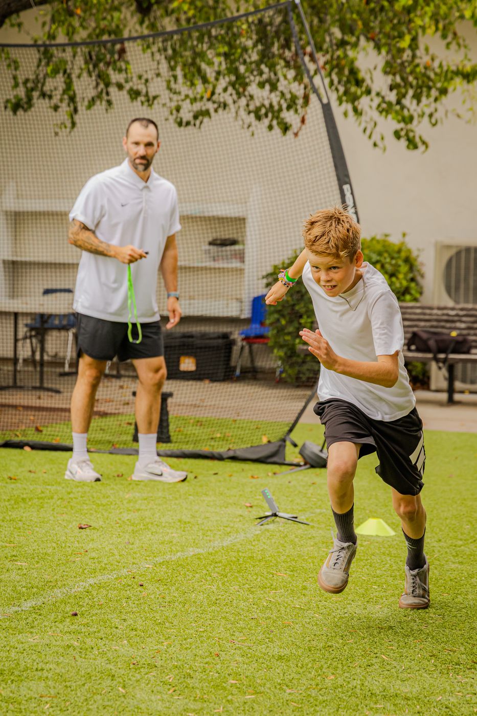Young athlete sprinting toward the camera
